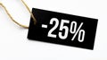 SALE 25 percents text on a black tag on a white paper background Royalty Free Stock Photo