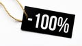 SALE 100 percents text on a black tag on a white paper background Royalty Free Stock Photo