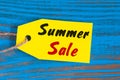 Sale price reduction tag for discounts. Summer sale pricetag at blue background