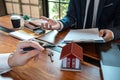 Sale purchase contract to buy a house, Real estate agent are presenting home loan and giving keys to customer after signing Royalty Free Stock Photo