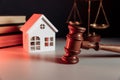 Sale of real property concept. Wooden model of house and gavel at notary office Royalty Free Stock Photo