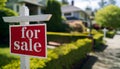 for sale red sign hanging on a white wooden stick on front of real estate Royalty Free Stock Photo