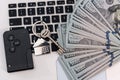 sale or rent, car and home keys wit hdollar bills over laptop keyboard Royalty Free Stock Photo