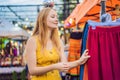 Sale, retail, shopping and clothing concept - Woman chooses clothes in the Asian market Royalty Free Stock Photo