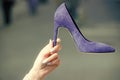 Sale in the shoe. glamour shoe blue color suede on female hand Royalty Free Stock Photo