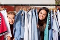 Women having fun at vintage clothing store hanger