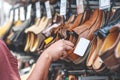 Sale, shopping, fashion, style and people concept - Man in the shop choosing new shoes for store shelf in mall Royalty Free Stock Photo