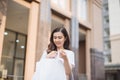 Sale, shopping, tourism and happy people concept - beautiful woman with shopping bags in the ctiy