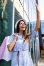 Beautiful woman with shopping bags in the ctiy. Sale, shopping, tourism and happy people concept Royalty Free Stock Photo