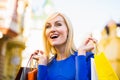 Sale, shopping, tourism and happy people concept - beautiful woman with shopping bags in the ctiy