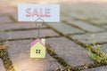 Sale sign with small model house - real estate buying concept.Copy space. home and life concept. Small model home with Royalty Free Stock Photo