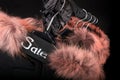 Sale sign. A lot of black coats, jacket with fur on hood hanging on clothes rack