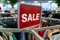 Sale Sign On Rail in Clothes Shop or Store Royalty Free Stock Photo