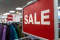 Sale Sign On Rail in Clothes Shop or Store Royalty Free Stock Photo