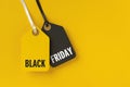 Sale tags with Black Friday written on yellow background Royalty Free Stock Photo