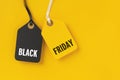 Sale tags with Black Friday written on yellow background Royalty Free Stock Photo