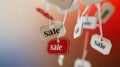 Sale Tags Hanging on Strings with Blurred Red and Blue Background Royalty Free Stock Photo