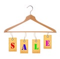 Sale tags on wooden clothes hanger isolated on white Royalty Free Stock Photo