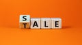 Sale or tale symbol. Turned wooden cubes and changed the concept word Tale to Sale. Beautiful orange table orange background, copy