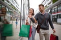 Sale, travel love consumerism and people concept. Happy couple with shopping bags in the city