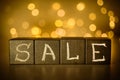 Sale word chalk written on black cubes on blurred bokeh background Royalty Free Stock Photo