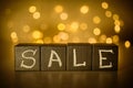 Sale word chalk written on black cubes on blurred bokeh background Royalty Free Stock Photo