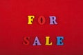 For sale word on red background composed from colorful abc alphabet block wooden letters, copy space for ad text. Learning english Royalty Free Stock Photo