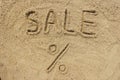 Sale word written on the sand at the beach, natural background Royalty Free Stock Photo