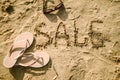 Sale written in the sand on a beach Royalty Free Stock Photo