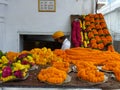 Sale of yellow and orange flowers bunches for offers at the indian temple, New Delhi, India