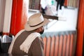 Senior local man wearing traditional poncho and hat at the beautiful streets of Salento an small