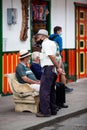 Senior local man wearing traditional poncho and hat at the beautiful streets of Salento an small