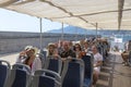 Group of happy tourists aboard a pleasure boat in the port of Salerno in Italy