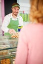 Salersman and costumer picking cookies Royalty Free Stock Photo