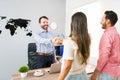 Sales agent greeting customers at his office