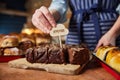 Sales Assistant In Bakery Putting Homemade Label Into Freshly Baked Baked Chocolate Brownies Royalty Free Stock Photo