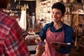 Sales Assistant With Credit Card Reader On Digital Tablet Royalty Free Stock Photo