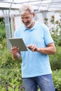 Sales Assistant In Garden Center With Digital Tablet Royalty Free Stock Photo