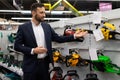 sales assistant in the store talks about gasoline chain saws