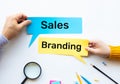 Sales and branding with marketing strategy concepts with taxt and on paper and worker hand