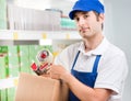 Sales clerk with cardboard box Royalty Free Stock Photo