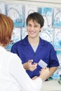 Sales clerk receiving credit card, vertical Royalty Free Stock Photo