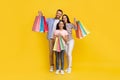 Sales Concept. Happy caucasian family of three holding shopping bags and smiling Royalty Free Stock Photo