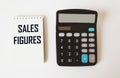 Sales figures - text on notepad, near calculator Royalty Free Stock Photo