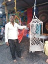 Salesman in shop. Morjim village, Goa, India