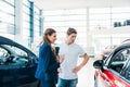 Sales manager describing car to customer Royalty Free Stock Photo