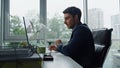 Sales manager making call in contemporary office. Smiling businessman talking