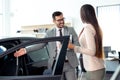 Sales manager at a showroom car is worth to the buyer Royalty Free Stock Photo