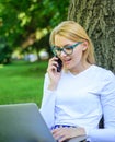 Sales manager occupation benefits. Woman with laptop in park order item on phone. Girl takes advantage of online Royalty Free Stock Photo