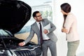 Sales manager at a showroom car is worth to the buyer Royalty Free Stock Photo